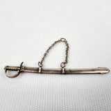 Gabriel Riddle london (C1830-1840) silver miniature sword in silver scabbard. This silver sword with its silver scabbard both have the makers name stamped on to them. G.Riddle London. The scabbard has it to the side and the sword is marked on the hilt or hand guard. Two minor dents and one small dent in the scabbard that does not effect the sword drawing out of it.  Measures: Height 6.1cm, Width 1cm, Depth 0.4cm.