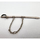 Gabriel Riddle london (C1830-1840) silver miniature sword in silver scabbard. This silver sword with its silver scabbard both have the makers name stamped on to them. G.Riddle London. The scabbard has it to the side and the sword is marked on the hilt or hand guard. Two minor dents and one small dent in the scabbard that does not effect the sword drawing out of it. Close up to the chain attached to sword case Measures: Height 6.1cm, Width 1cm, Depth 0.4cm.