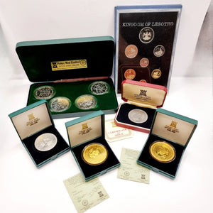 Collection of 8 Pobjot Mint Isle man Crowns along with 1979 Lesotho Coinage Set