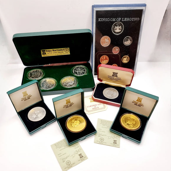 Collection of 8 Pobjot Mint Isle man Crowns along with 1979 Lesotho Coinage Set