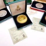 Collection of 8 Pobjot Mint Isle man Crowns along with 1979 Lesotho Coinage Set