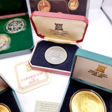 Collection of 8 Pobjot Mint Isle man Crowns along with 1979 Lesotho Coinage Set
