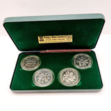 Collection of 8 Pobjot Mint Isle man Crowns along with 1979 Lesotho Coinage Set