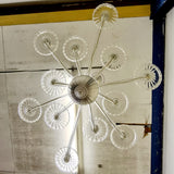 . Twelve art deco crystal glass dishes, that sit on various lengths of crystal glass arms. Giving the chandelier a sunburst look from the underneath.