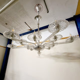 A stunning 12 branch venetian art deco chandelier, these amazing chandelier is made out of crystal glass and really reflects the light when it's on. Twelve art deco crystal glass dishes, that sit on various lengths of crystal glass arms. Giving the chandelier a sunburst look from the underneath. 
