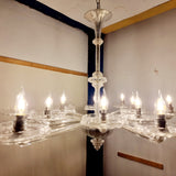A stunning 12 branch venetian art deco chandelier, these amazing chandelier is made out of crystal glass and really reflects the light when it's on. Twelve art deco crystal glass dishes, that sit on various lengths of crystal glass arms. Giving the chandelier a sunburst look from the underneath. The chandelier is working and looks even better, in person. 
