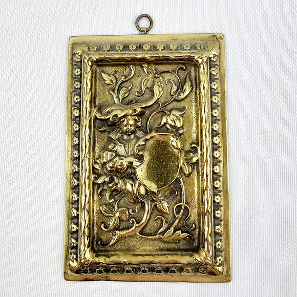 Antique Brass Plaque depicting a Boy in Foliage