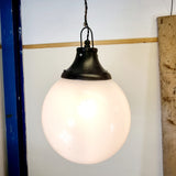Pair of vintage industrial lights with Cast iron light fixing and a perspex ball shape shade. These have a great industrial look and style to them showing signs of wear with Scuffs and scraps to the shade of each light shade. Both lights in working order and look great hung up and lit up.   Measures: Height 60cm, Diameter approximately 36cm. Showing light working