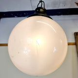 Pair of vintage industrial lights with Cast iron light fixing and a perspex ball shape shade. These have a great industrial look and style to them showing signs of wear with Scuffs and scraps to the shade of each light shade. Both lights in working order and look great hung up and lit up.   Measures: Height 60cm, Diameter approximately 36cm.