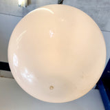 Pair of vintage industrial lights with Cast iron light fixing and a perspex ball shape shade. These have a great industrial look and style to them showing signs of wear with Scuffs and scraps to the shade of each light shade. Both lights in working order and look great hung up and lit up.   Measures: Height 60cm, Diameter approximately 36cm.