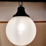 Pair of vintage industrial lights with Cast iron light fixing and a perspex ball shape shade. These have a great industrial look and style to them showing signs of wear with Scuffs and scraps to the shade of each light shade. Both lights in working order and look great hung up and lit up.   Measures: Height 60cm, Diameter approximately 36cm.