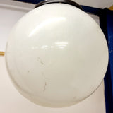 Pair of vintage industrial lights with Cast iron light fixing and a perspex ball shape shade. These have a great industrial look and style to them showing signs of wear with Scuffs and scraps to the shade of each light shade. Both lights in working order and look great hung up and lit up.   Measures: Height 60cm, Diameter approximately 36cm.