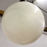 Pair of vintage industrial lights with Cast iron light fixing and a perspex ball shape shade. These have a great industrial look and style to them showing signs of wear with Scuffs and scraps to the shade of each light shade. Both lights in working order and look great hung up and lit up.   Measures: Height 60cm, Diameter approximately 36cm.