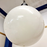 Pair of vintage industrial lights with Cast iron light fixing and a perspex ball shape shade. These have a great industrial look and style to them showing signs of wear with Scuffs and scraps to the shade of each light shade. Both lights in working order and look great hung up and lit up.   Measures: Height 60cm, Diameter approximately 36cm.