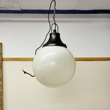 Pair of vintage industrial lights with Cast iron light fixing and a perspex ball shape shade. These have a great industrial look and style to them showing signs of wear with Scuffs and scraps to the shade of each light shade. Both lights in working order and look great hung up and lit up.   Measures: Height 60cm, Diameter approximately 36cm.