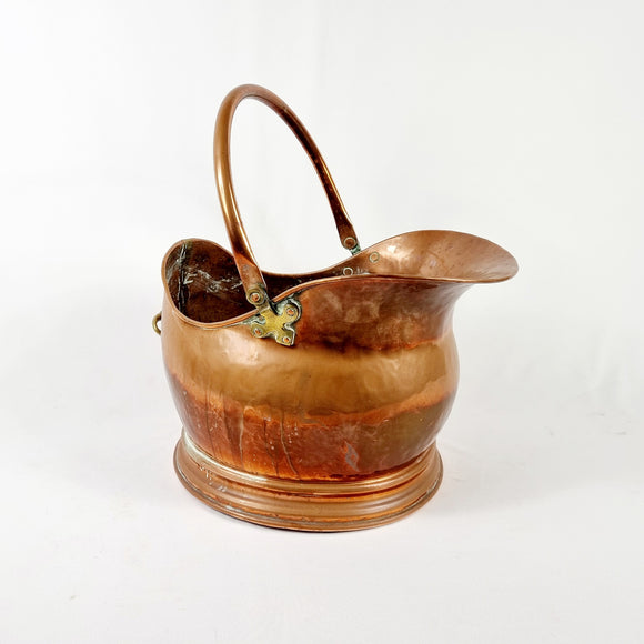 19th century Victorian copper coal scuttle. This coal scuttle features brass mounts to the side the are attached to a hinged copper handle and a single brass handle at the back of the scuttle. The coal scuttle has its normal signs of wear from being used for about 150 years as a coal scuttle should for its age, from denting of the copper from being used. Apart from that the scuttle is in very good condition, and very sturdy, ready to use straight away.  Measures: Height 24.6cm, Width 30.6cm, Depth 40cm.