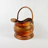 19th century Victorian copper coal scuttle. This coal scuttle features brass mounts to the side the are attached to a hinged copper handle and a single brass handle at the back of the scuttle. The coal scuttle has its normal signs of wear from being used for about 150 years as a coal scuttle should for its age, from denting of the copper from being used. Apart from that the scuttle is in very good condition, and very sturdy, ready to use straight away.  Measures: Height 24.6cm, Width 30.6cm, Depth 40cm.