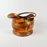 19th century Victorian copper coal scuttle. This coal scuttle features brass mounts to the side the are attached to a hinged copper handle and a single brass handle at the back of the scuttle. The coal scuttle has its normal signs of wear from being used for about 150 years as a coal scuttle should for its age, from denting of the copper from being used. Apart from that the scuttle is in very good condition, and very sturdy, ready to use straight away.  Measures: Height 24.6cm, Width 30.6cm, Depth 40cm.