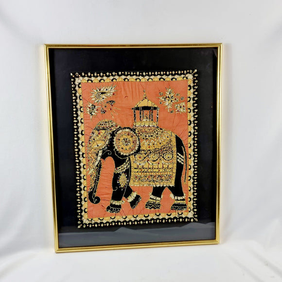 Large decorative Indian picture of an elephant made of silk, golden coloured thread and decorated in sequins. On a black background all housed within a golden frame.  Measures: Height 66.9cm, Width 56.1cm, Depth 4cm. 