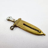 Brass and mother of pearl novelty cigar cutter. Showing the back of the cutter signs or ware and showing the slight crack in the mother of pearl