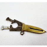 Brass and mother of pearl novelty cigar cutter in the form of a dagger. Marked M.S. This is a charming a antique cigar cutter that would make a great addition for a collector or for just having one of those one of pieces. The mother of pearl is cracked on one side of the handle bit is still securely on with no movement.   Measures: Height 5.3cm, Width 2cm, Depth 0.5cm.